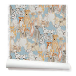 Partially unrolled wallpaper with a pattern of many different types of illustrated watercolor dogs. Background is light blue.