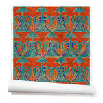Wallpaper roll with a stamped painted floral motif in vibrant red and cobalt on an emerald green background