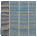 Detail of the Jasper Waffle Rug in Chalcedony, a large scale plaid pattern of denim blue, black, yellow and pale turqouise. 