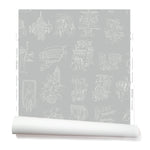 Partially unrolled wallpaper with white hand-drawn illustrations of New York City landmarks on a gray background.