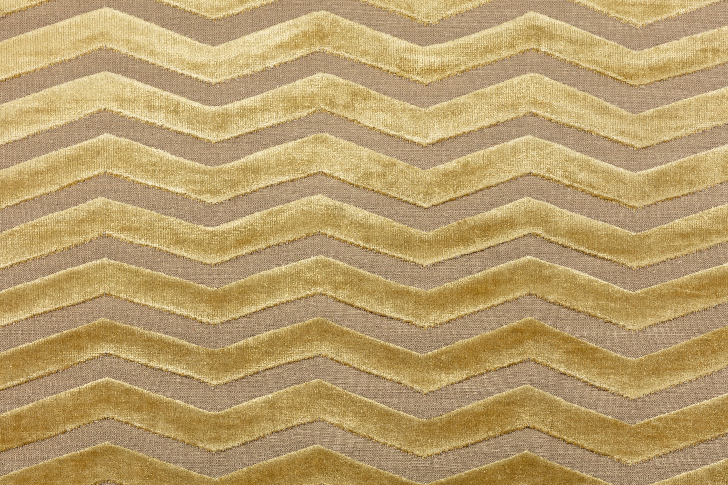 Detail of the Penta Chevron Rug in Lemon Topaz a lemon yellow chevron pattern on a taupe field with a wide solid border. 
