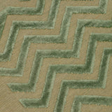 Detail of the Penta Chevron Rug in Pale Jade a light green chevron pattern on a lime green  field with a wide solid border. 