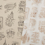 Two overlapping linen swatches in different colorways of the same hand-drawn New York City landmarks pattern.