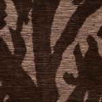 Detail of Capri Rug with a large abstract design shades of brown over varied stried lighter color background