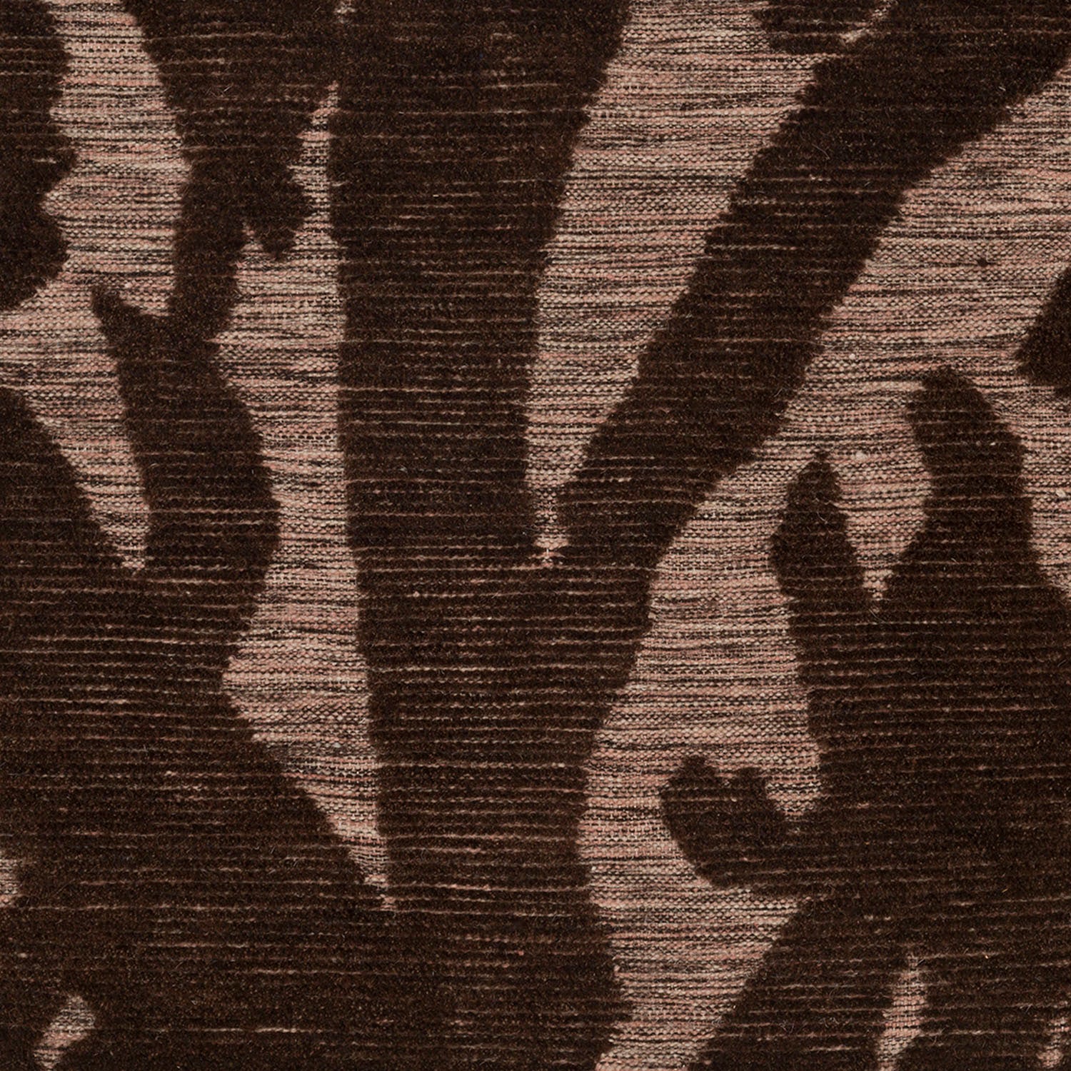 Detail of Capri Rug with a large abstract design shades of brown over varied stried lighter color background