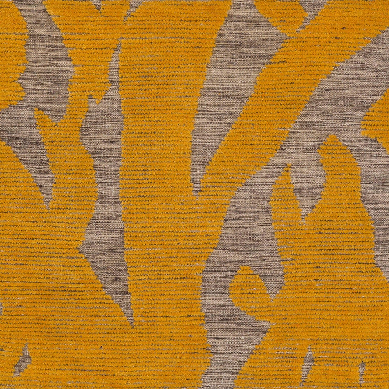 Detail of Capri Rug with a large abstract design shades of yellow over varied stried lighter neutral color background