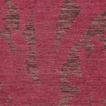 Detail of Capri Rug with a large abstract design shades of pink over varied stried lighter color background