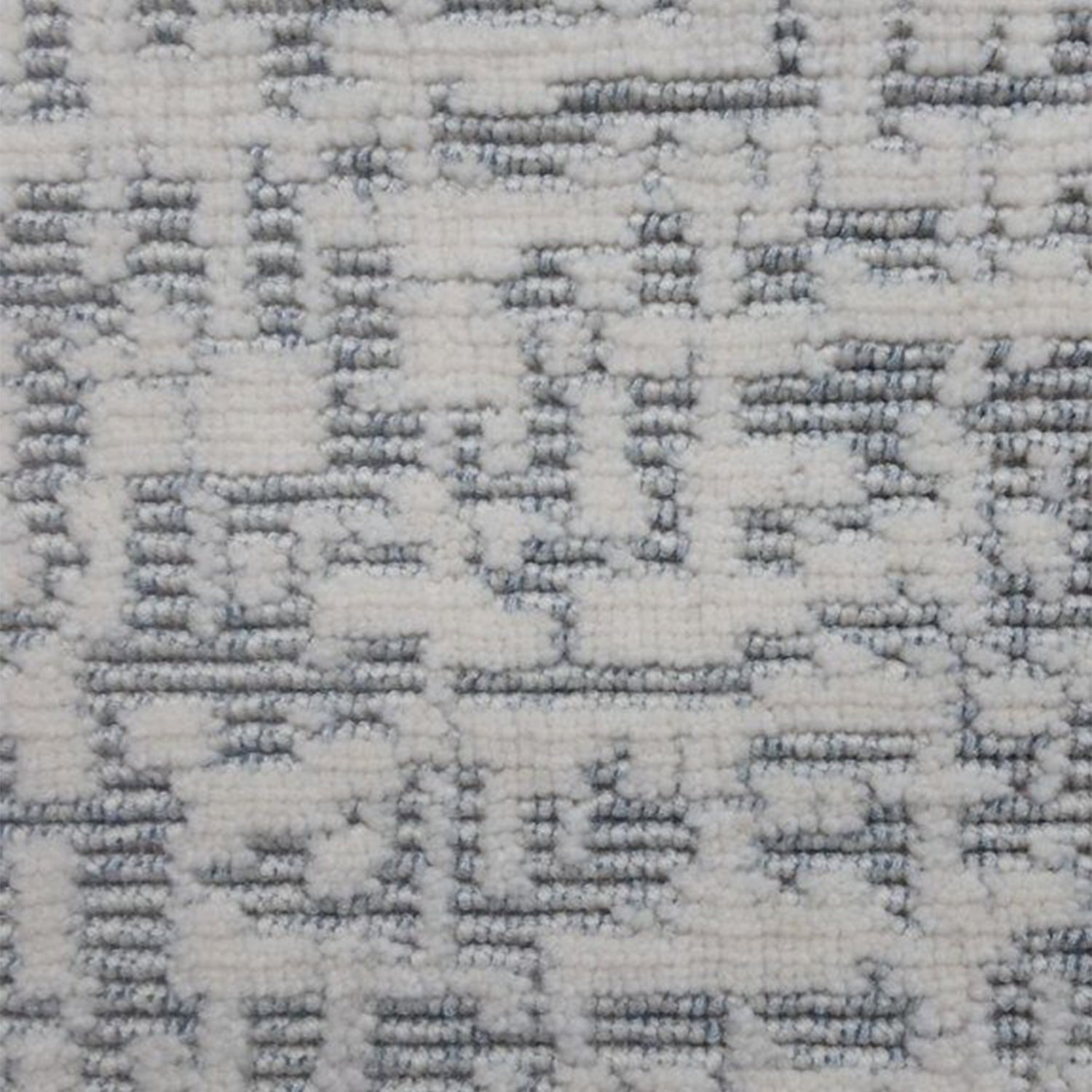 Wool-polyester broadloom carpet swatch in an impressionistic repeating pattern of white on a silver field.