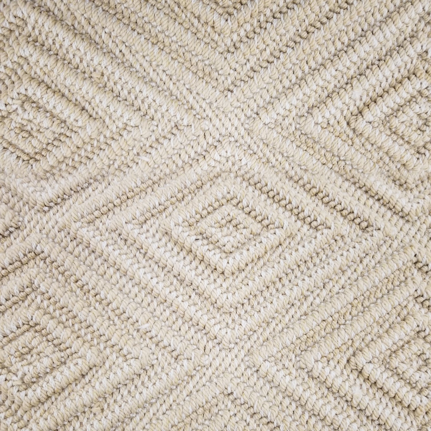 Wool broadloom carpet swatch woven in a dimensional diamond print in light gold.