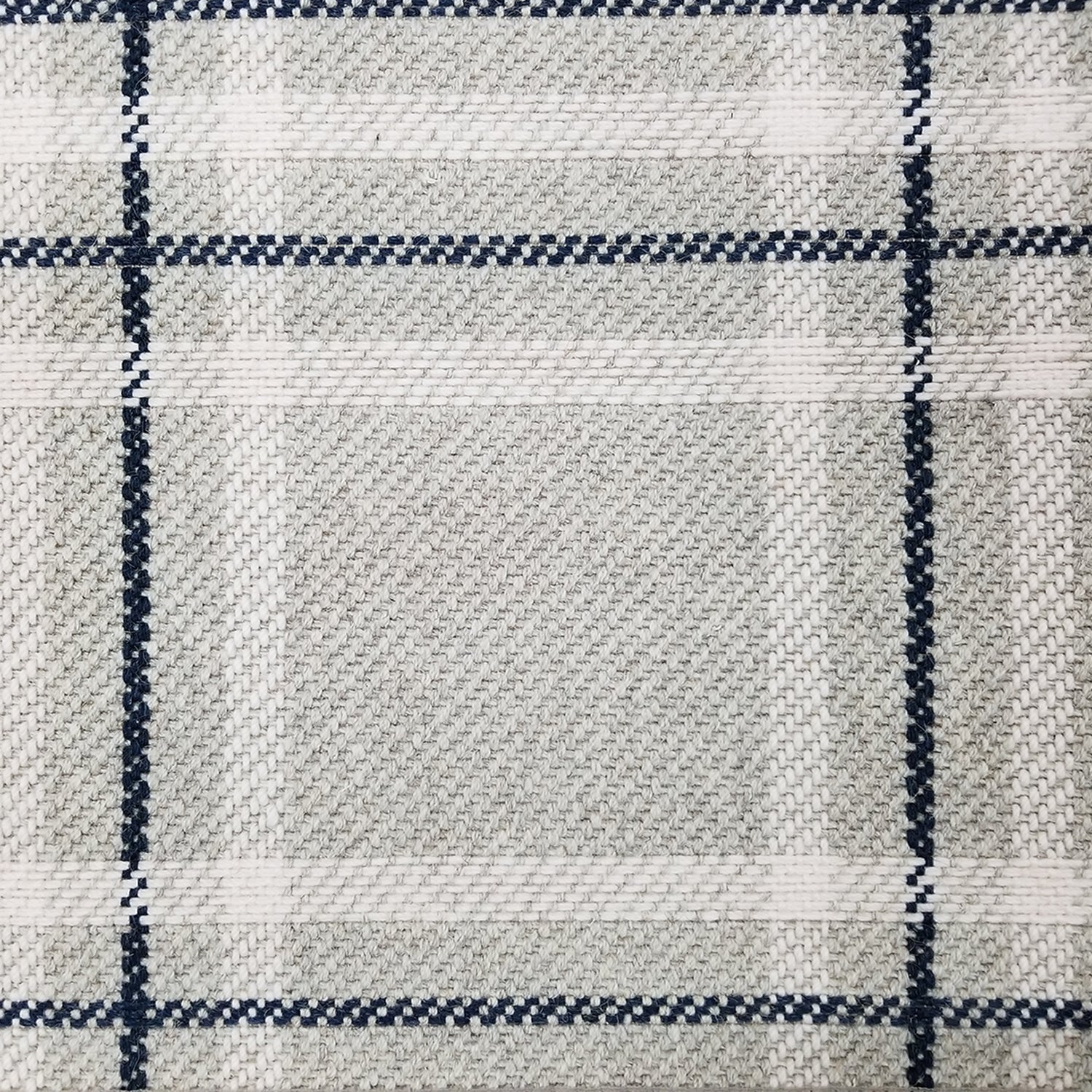 Wool broadloom carpet swatch in a plaid print in shades of cream, tan and navy.