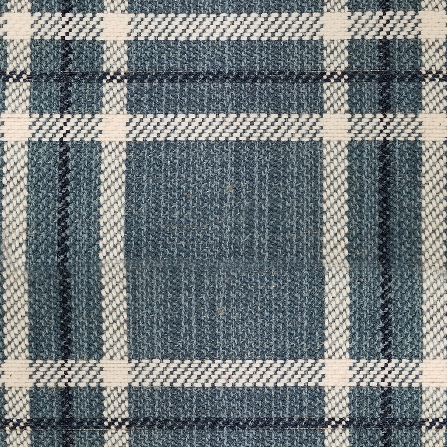 Wool broadloom carpet swatch in a plaid print in shades of tan, navy and black.