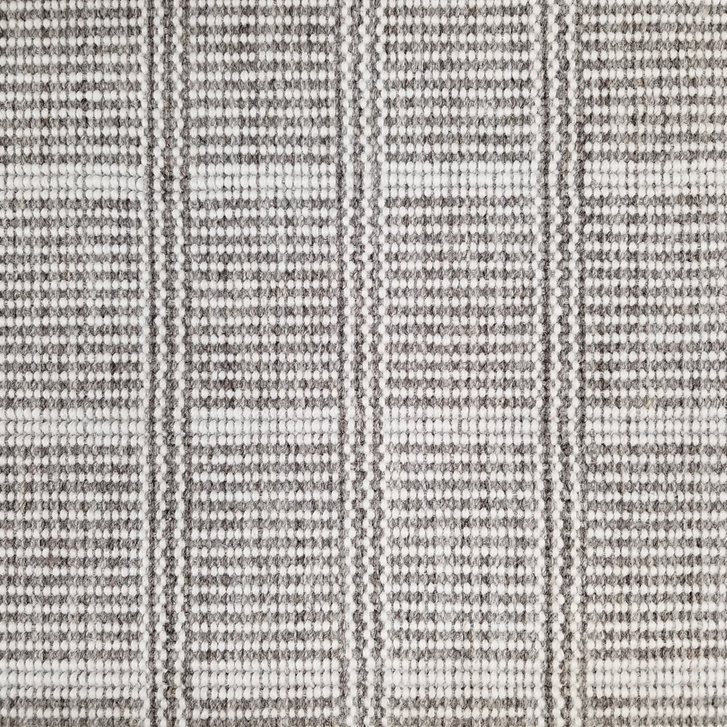 Wool broadloom carpet swatch in a plaid print in shades of gray and white.