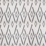 Woven broadloom carpet swatch in a repeating irregular diamond pattern in charcoal on a cream field.