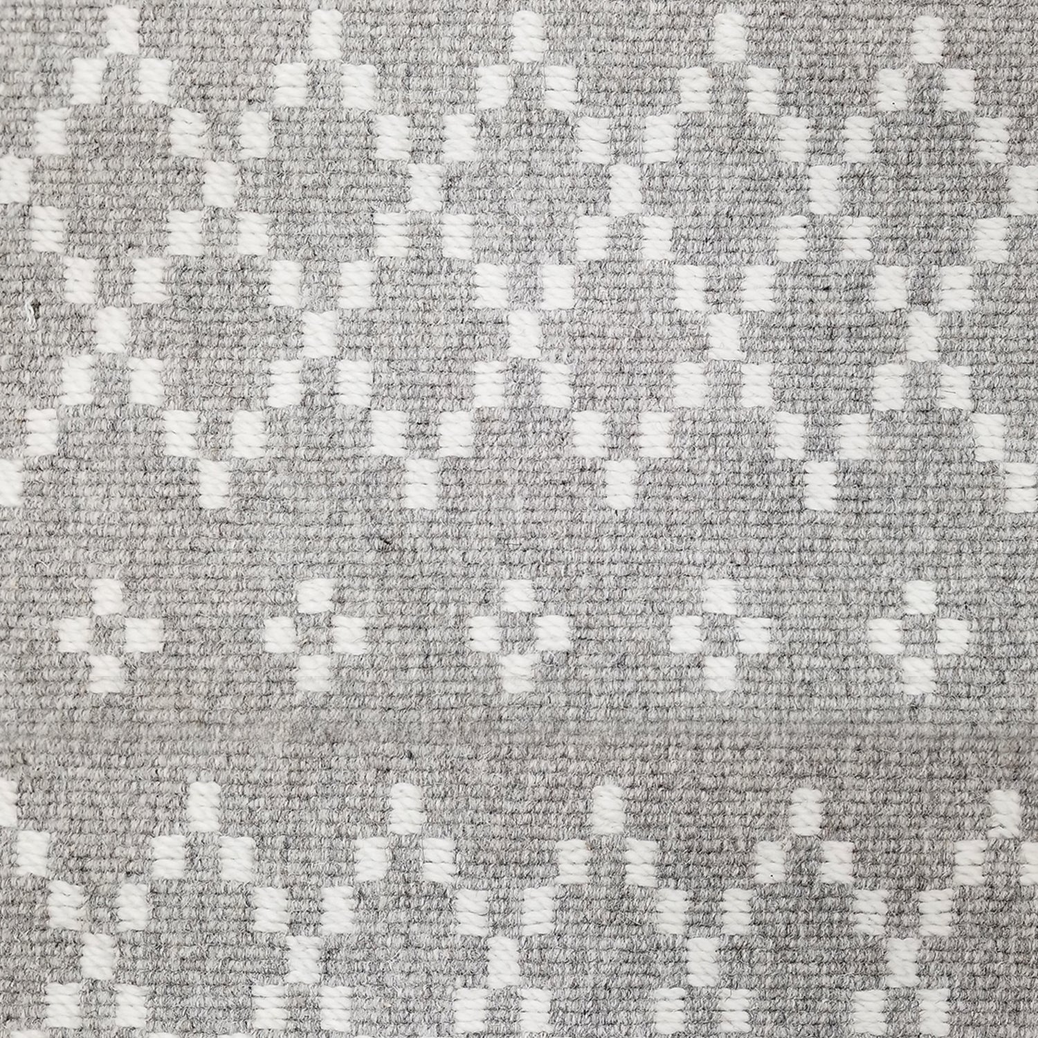 Wool broadloom carpet swatch in a repeating diamond print in white on a light gray field.