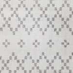 Wool broadloom carpet swatch in a repeating diamond print in light gray on an ivory field.