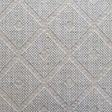 Wool broadloom carpet swatch in a repeating diamond check pattern in cream and light green.