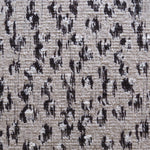 Wool broadloom carpet swatch in a painterly floral pattern in black and cream on a brown field.