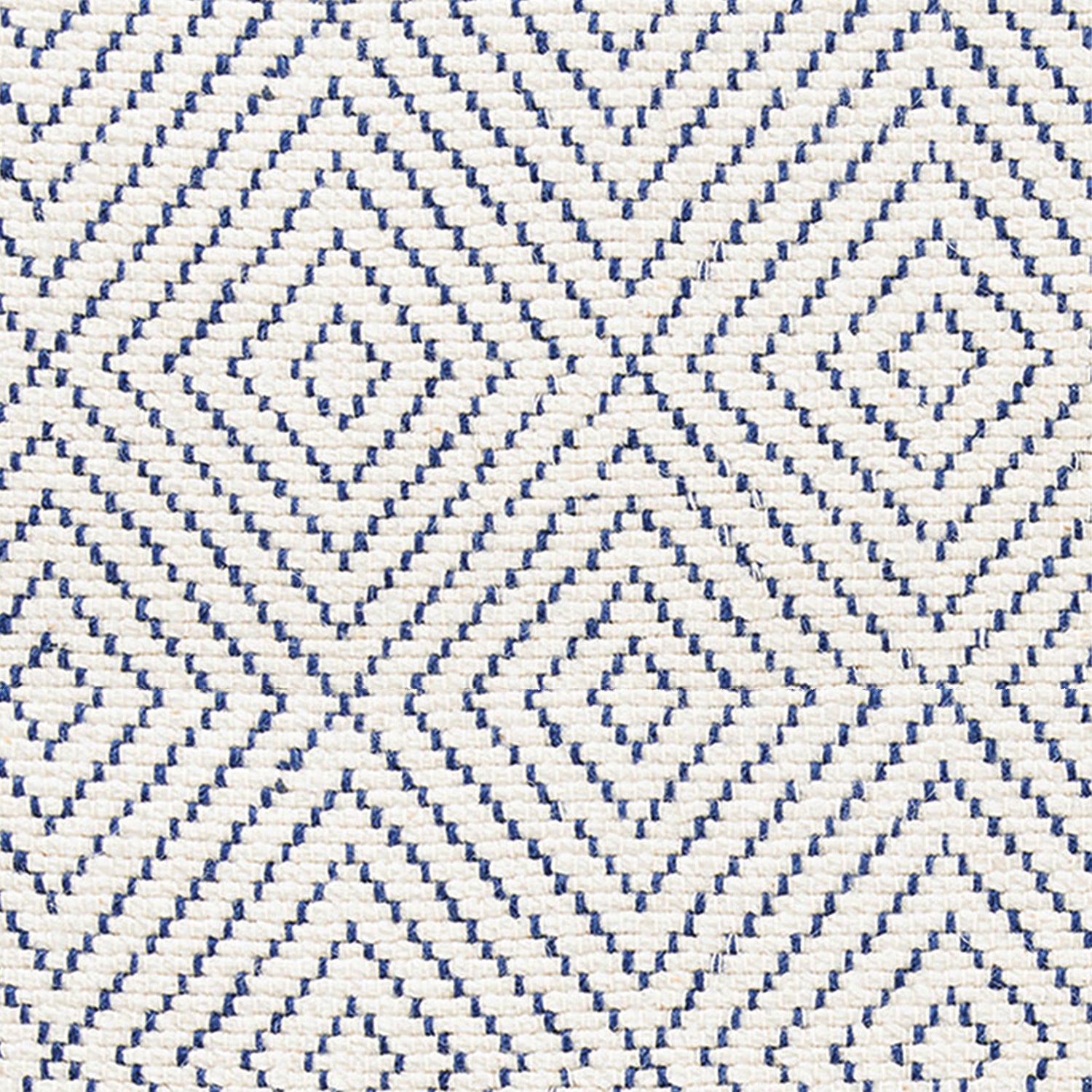 Wool broadloom carpet swatch in a graduated diamond print in navy on a cream field.