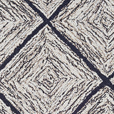 Wool broadloom carpet swatch in a diamond lattice print in cream and gold on a charcoal field.