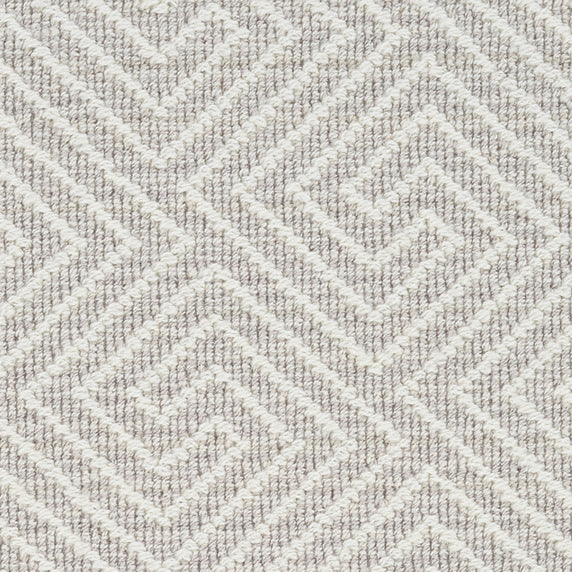 Wool broadloom carpet swatch in a high-pile interlocking geometric pattern in white and light brown.