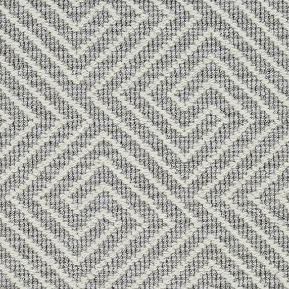 Wool broadloom carpet swatch in a high-pile interlocking geometric pattern in cream and gray.