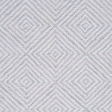 Wool broadloom carpet swatch in a dense repeating diamond print in shades of mauve and cream.