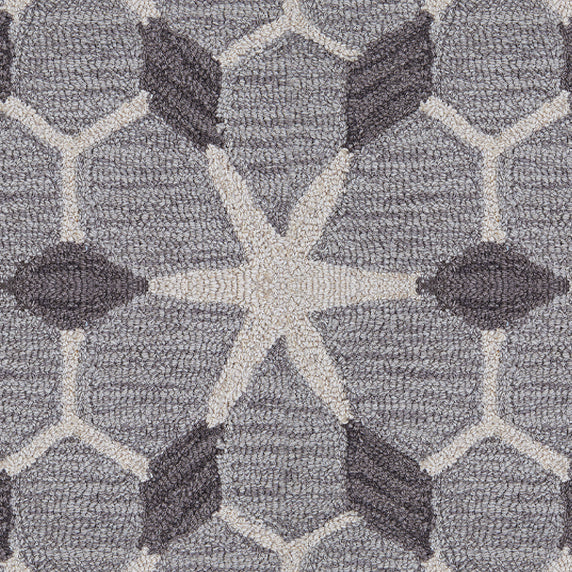 Wool broadloom carpet swatch in a geometric lattice pattern in cream and charcoal on a gray field.