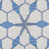 Wool broadloom carpet swatch in a geometric lattice pattern in shades of blue on a cream field.
