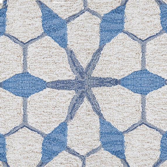 Wool broadloom carpet swatch in a geometric lattice pattern in shades of blue on a cream field.