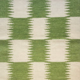 Woven rug swatch in an Ikat grid pattern in white and green.
