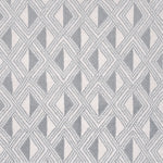 Detail of a woven high-pile rug in an interlocking diamond pattern in gray and white.