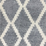 Wool-blend broadloom carpet swatch in a cream and gray diamond lattice print.
