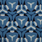 Detail of Gigi Rug featuring a geometric floral motif with a mix of cut pile and linear loops in ivory and shades of blue