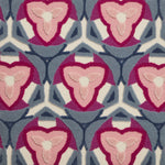 Detail of Gigi Rug featuring a geometric floral motif with a mix of cut pile and linear loops in periwinkle, ivory and shades of pink
