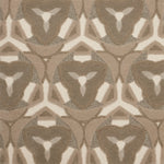 Detail of Gigi Rug featuring a geometric floral motif with a mix of cut pile and linear loops in shades of ecru, tan and ivory