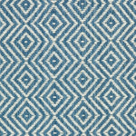 Wool broadloom carpet swatch in a diamond lattice weave in blue and cream.