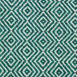 Wool broadloom carpet swatch in a diamond lattice weave in turquoise and white.