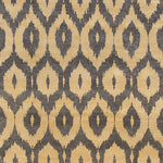 Detail of a woven rug with a grey and beige ikat diamond motif.
