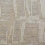 Woven rug swatch in an overlapping hand-drawn rectangle pattern in shades of cream and light gray.