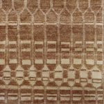 Woven high-pile rug swatch in an elongated linear honeycomb print in tan on a cream field.