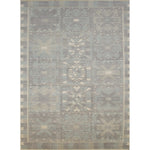 Large rectangular rug in a repeating abstract geometric pattern with a border of jagged geometric shapes, all in shades of gray.