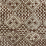 Woven high-pile rug swatch in a dense geometric pattern of diamonds in various sizes in shades of brown and cream.