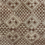 Woven high-pile rug swatch in a dense geometric pattern of diamonds in various sizes in shades of brown and cream.
