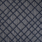 Wool-blend broadloom carpet swatch in a dimensional lattice print in navy on a mottled gray and cream field.