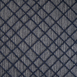 Wool-blend broadloom carpet swatch in a dimensional lattice print in navy on a mottled gray and cream field.