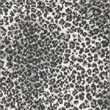 Wool broadloom carpet swatch in a cheetah print in charcoal and gray on a cream field.