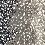 Wool broadloom carpet swatch in a white leopard print on an ombré background of black and gray.