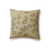 A square throw pillow in a large-scale minimal floral print in shades of yellow, peach and green on a light blue background.