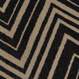 Detail of the Vertical Zig-Zag Rug in Onyx-Sandstone, a zig zag pattern in mixed widths in black and taupe.
