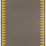 Waver Rug in Cardinal Yellow, a dark taupe field with a yellow flame stitch border. 